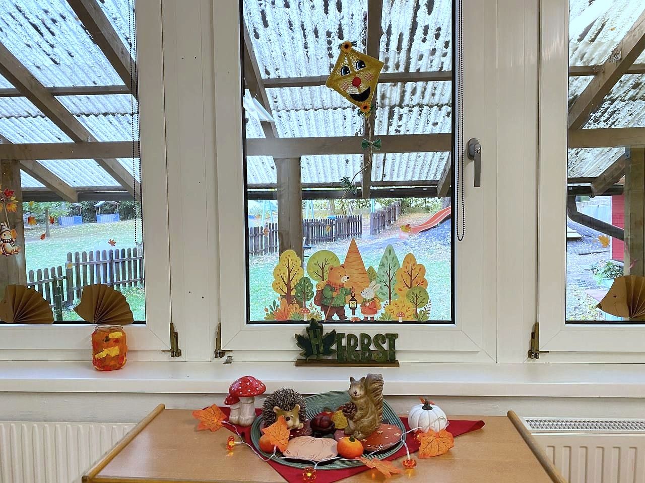 Fenster mit Herbstbildern und Blick in den Garten